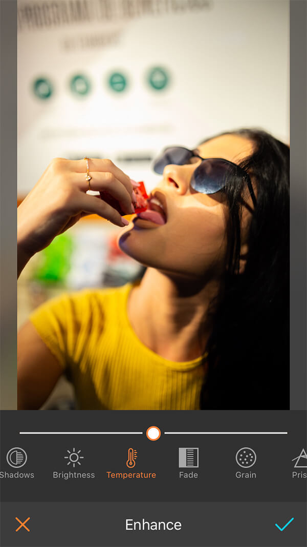 woman in yellow shirt with black hair and sunglasses