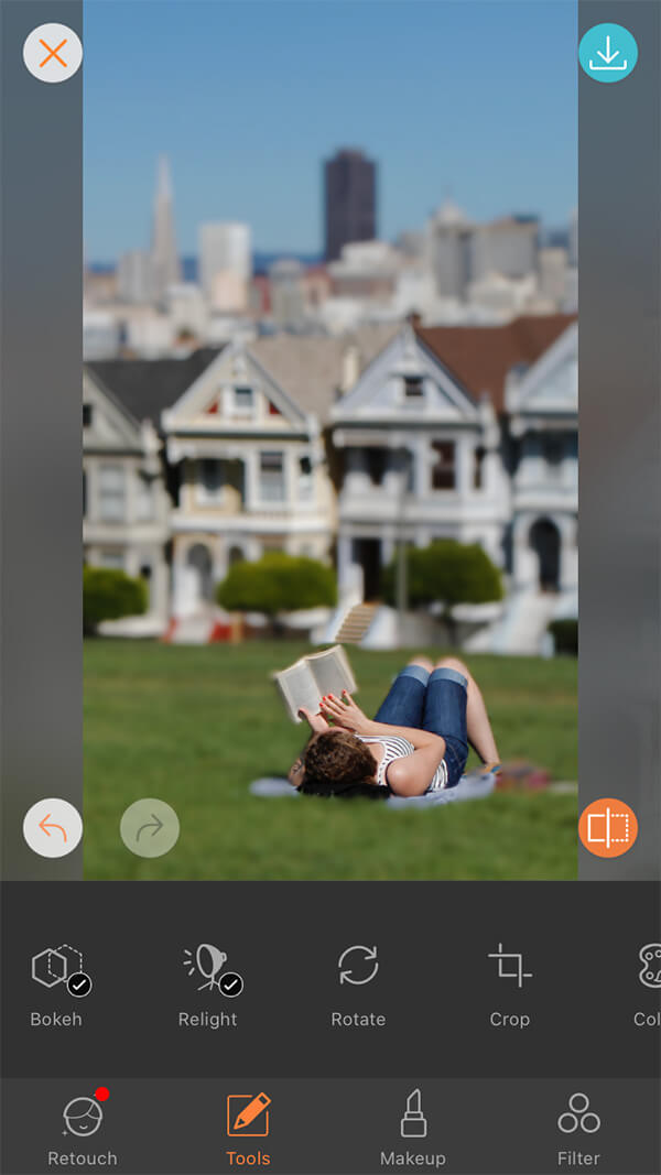 woman reads book on green lawn in San Francisco park