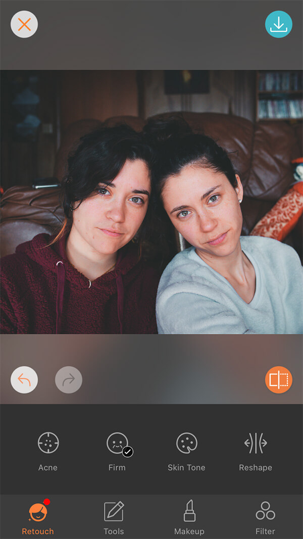 photo of female twins one wearing a red hoodie and the other in grey sweater