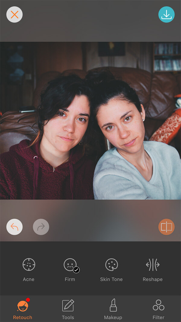 photo of female twins one wearing a red hoodie and the other in grey sweater