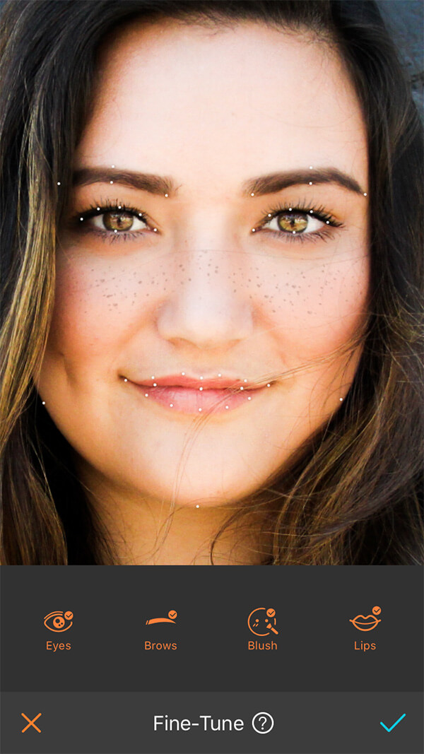 closeup of a woman in a green sweater with hazel eyes and freckles