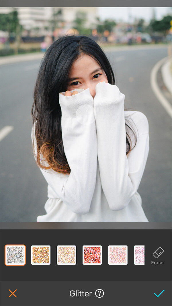 girl with black hair in white sweater standing in the road