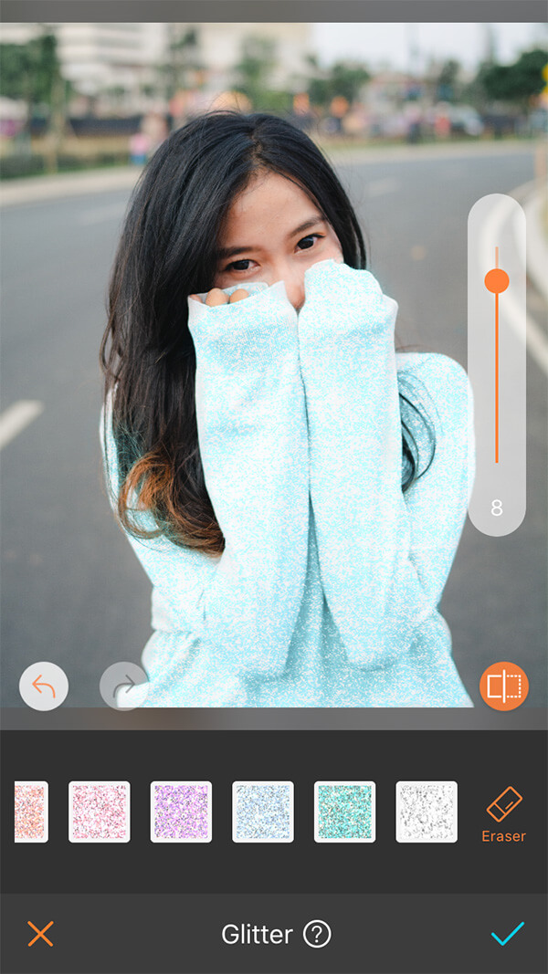 girl with black hair in blue sweater standing in the road