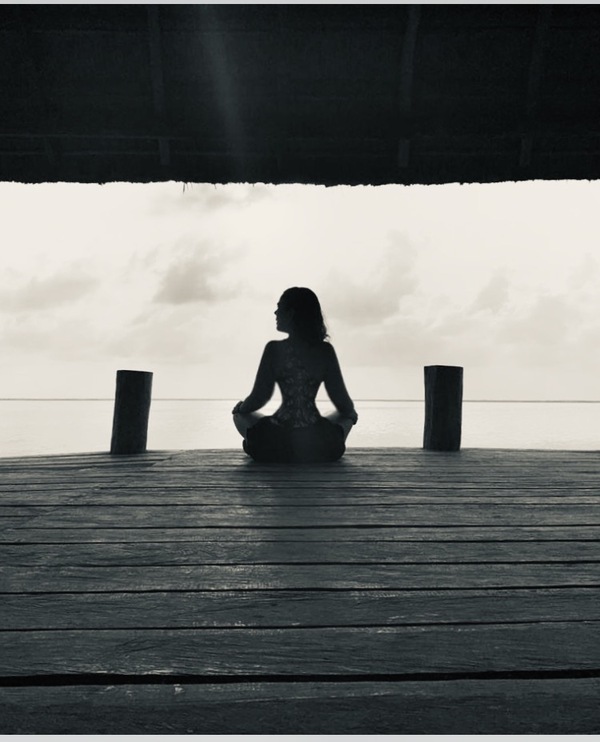 mujer meditando en una cabaña al aire libre 