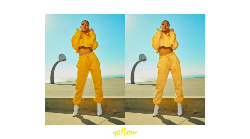 woman wearing yellow track suit with a bright blue sky in the background