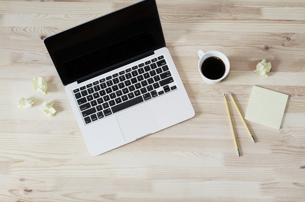 flat lay of MacBook, coffee and post its