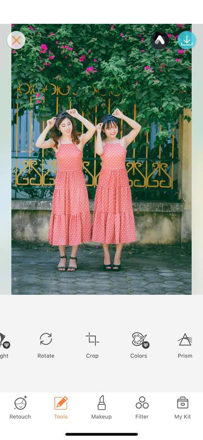 two women standing on the sidewalk wearing red polka dot dresses