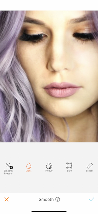 zoomed in photo of woman's face with purple hair