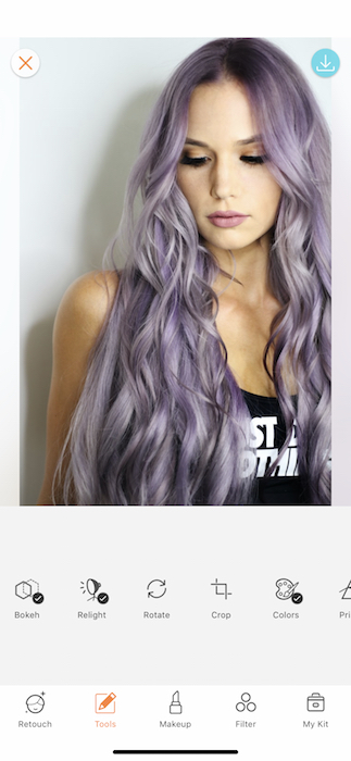 close up of woman with purple hair in front of white background