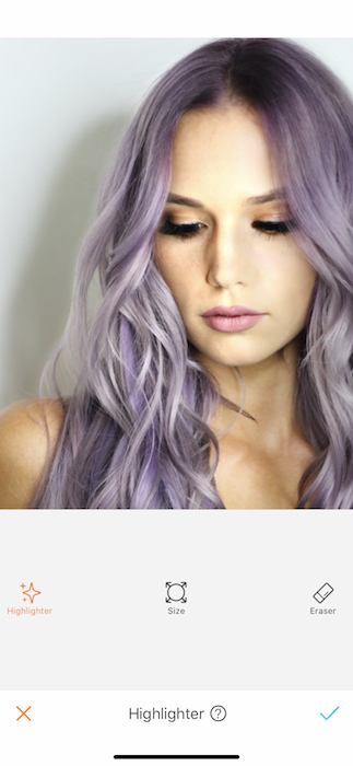 close up of woman with purple hair in front of white background