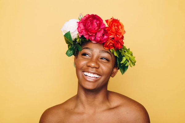 Picture of bald black woman with a crown of flowers