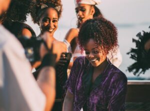 Picture of a woman with friends at a party being edited by AirBrush