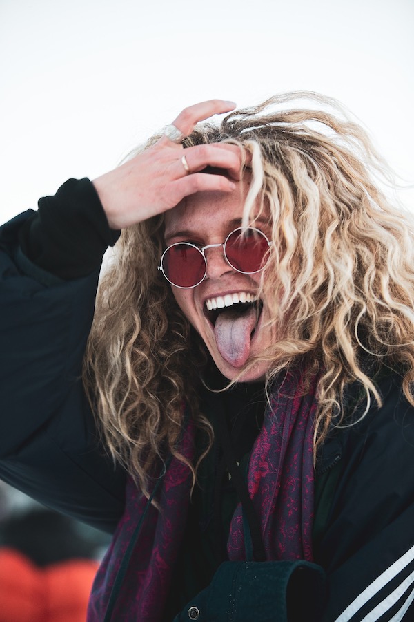 Man with blonde hair and red sunglasses