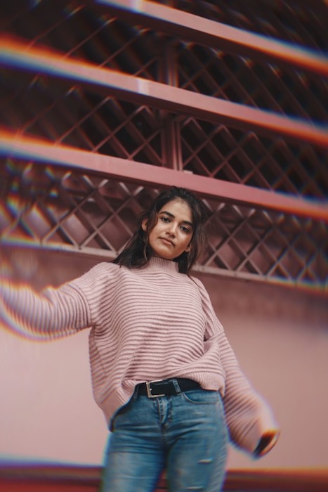 woman in pink sweater posing to the camera