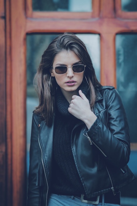 woman wearing black leather jacket and sunglasses