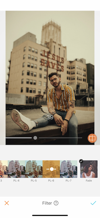 man sitting on rooftop in front of city skyline