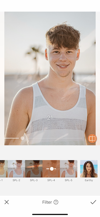 young man in white and grey tank top at the beach