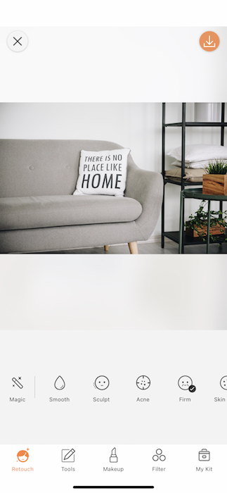 gray sofa with pillow that says "There's no place like home"