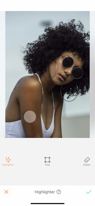 black woman wearing sunglasses and a white tank top