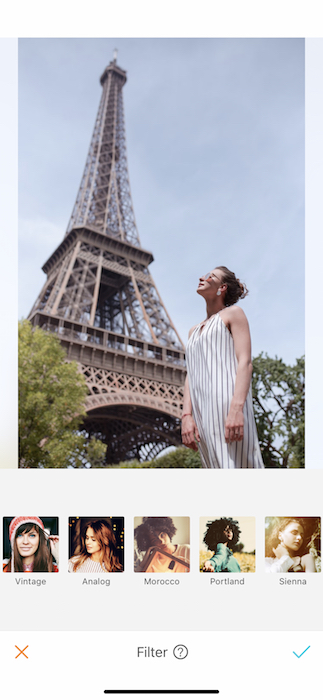 white woman standing in front of the Eiffel Tower