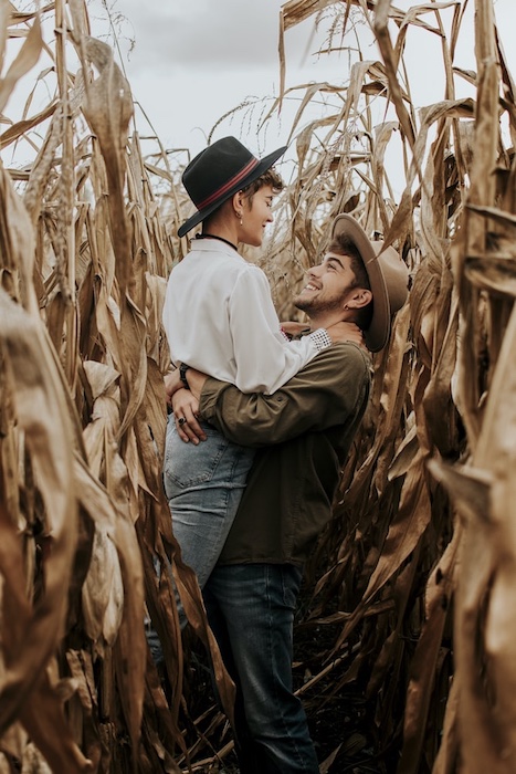 smiling couple embracing in a corn field