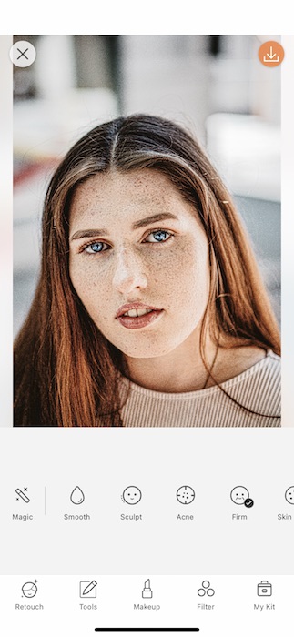 Picture of a white woman with freckles being edited by AirBrush with makeup tool