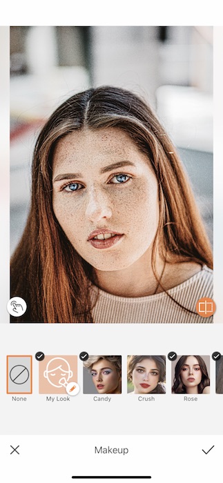 Picture of a white woman with freckles being edited by AirBrush with makeup tool
