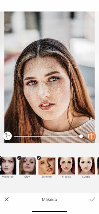 Picture of a white woman with freckles being edited by AirBrush with makeup tool