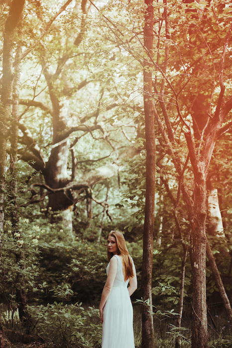 Picture of a white woman in the forest with the Flame Filter