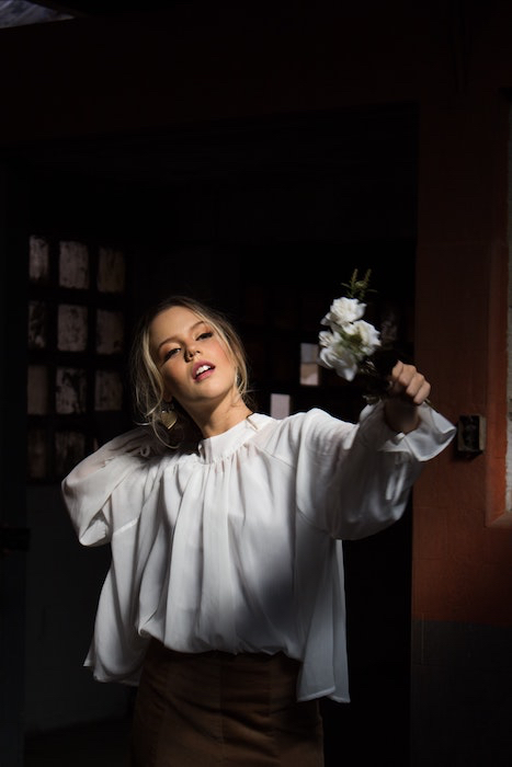 Picture of a white woman holding flowers