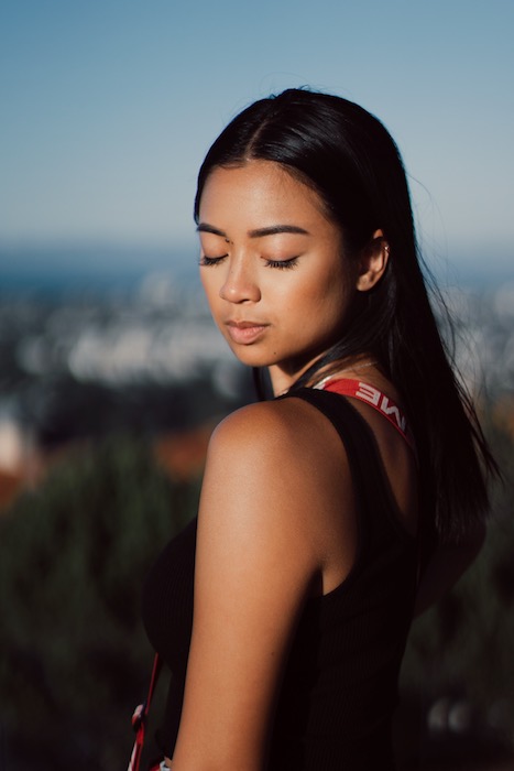 Picture of a woman posing and looking down being edited by AirBrush