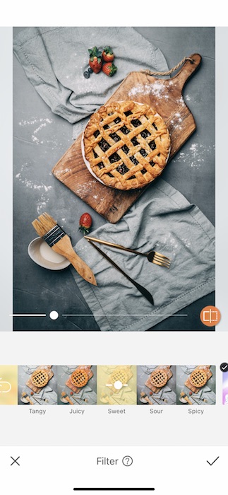 blueberry pie on cutting board with ingredients