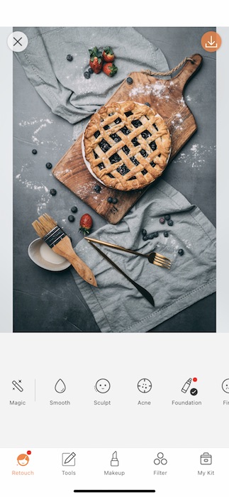 pie on cutting board surrounded by fruits