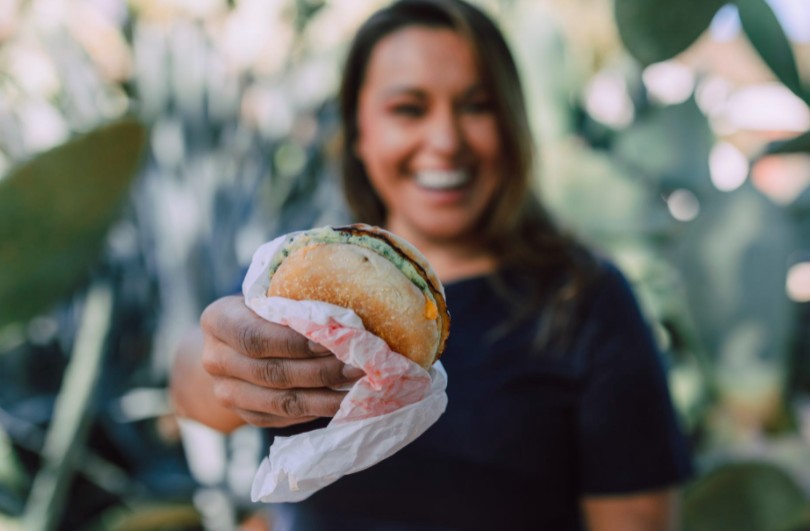 happy girl holding a burger