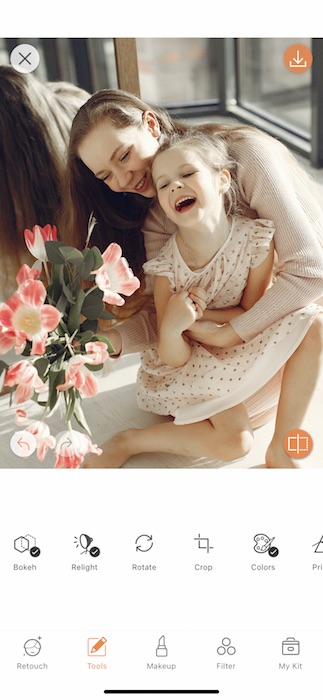 closeup of mother hugging toddler daughter and laughing