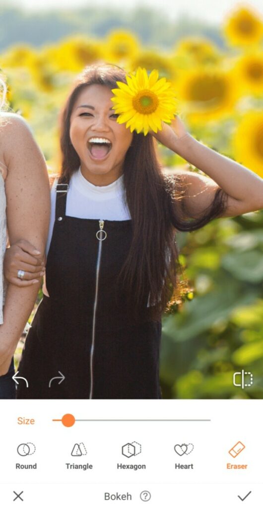 laughing woman holding a sunflower