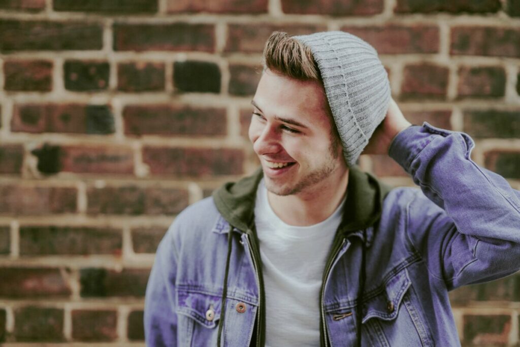 Cancer photo edit of a man wearing a denim jacket and grey knit hat