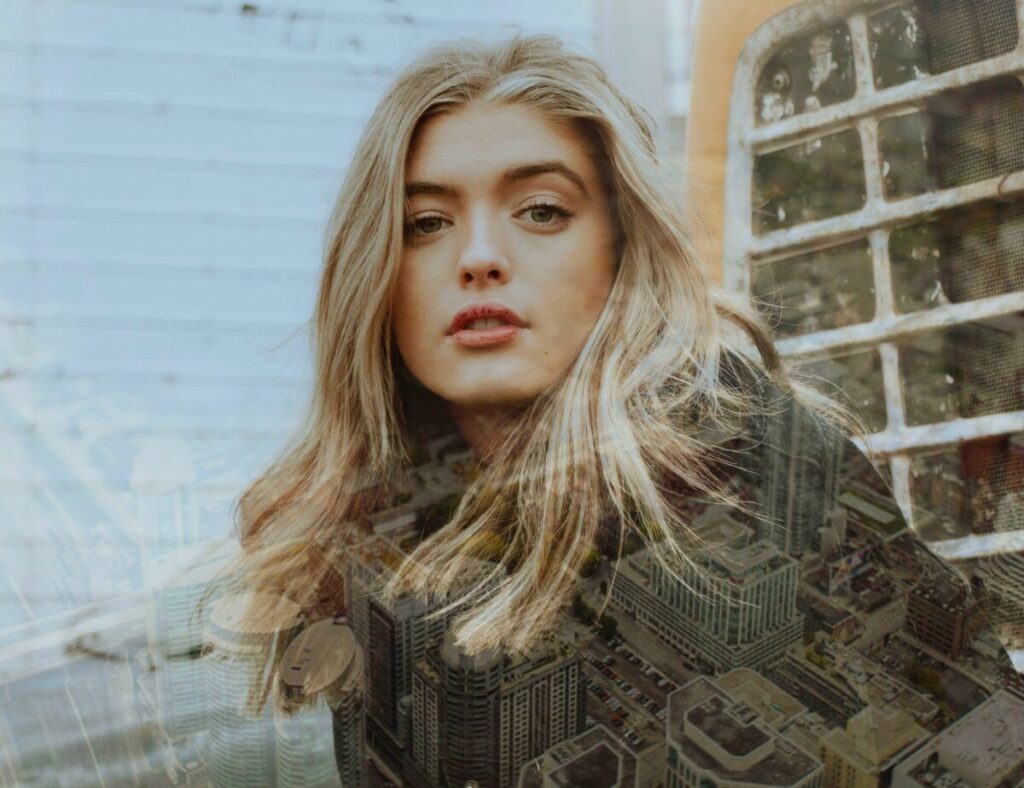 Photo of blonde woman with Metro filter creating a layer of city skyline 