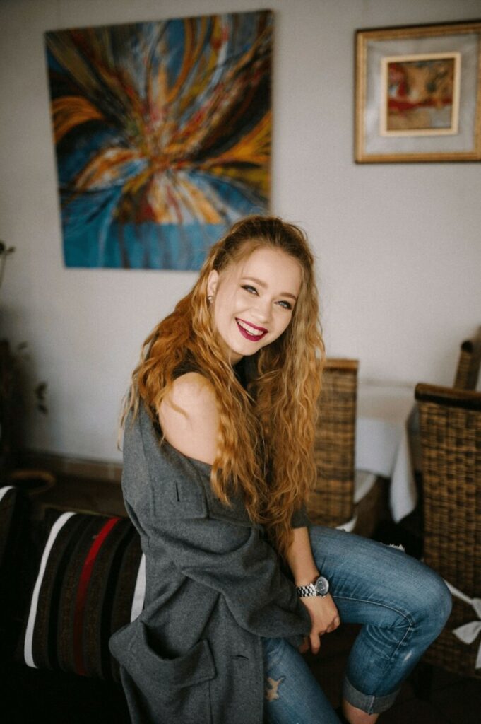 woman sitting on the arm of a couch