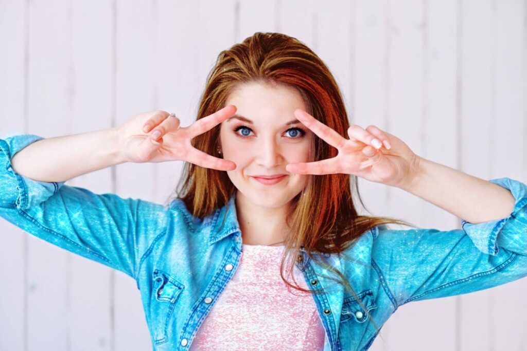 Sailor Moon edit with woman wearing chambray shirt making the peace sign over her eyes