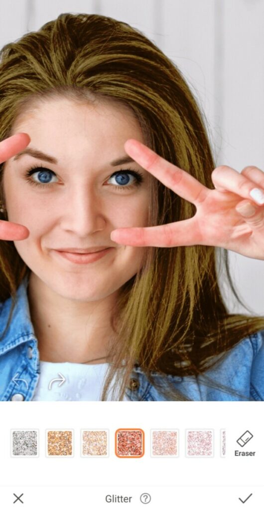 closeup of woman making peace signs over her eyes