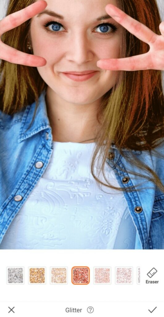 closeup of woman making peace signs over her eyes