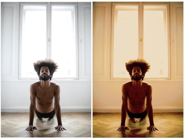 homem negro praticando ioga no chão