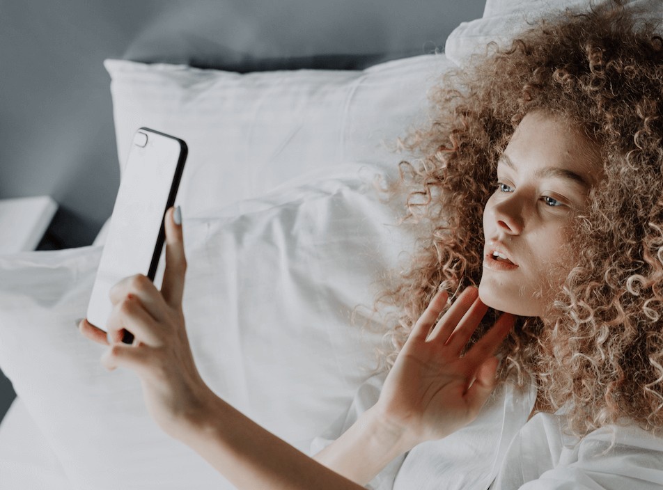 woman takes a photo while lying down