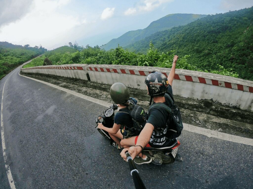 photo of two people riding a motorcycle