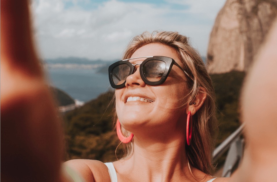 woman with sunglasses taking a selfie