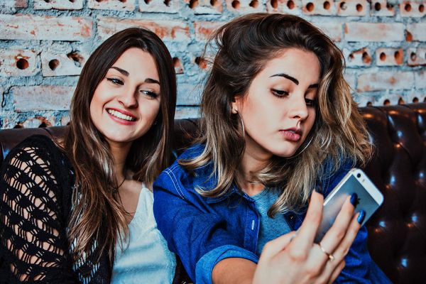 two friends pose for a selfie