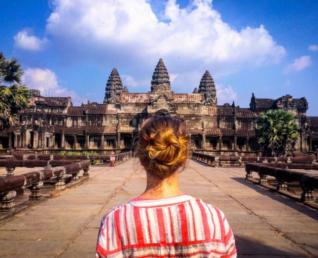 woman facing ancient temple