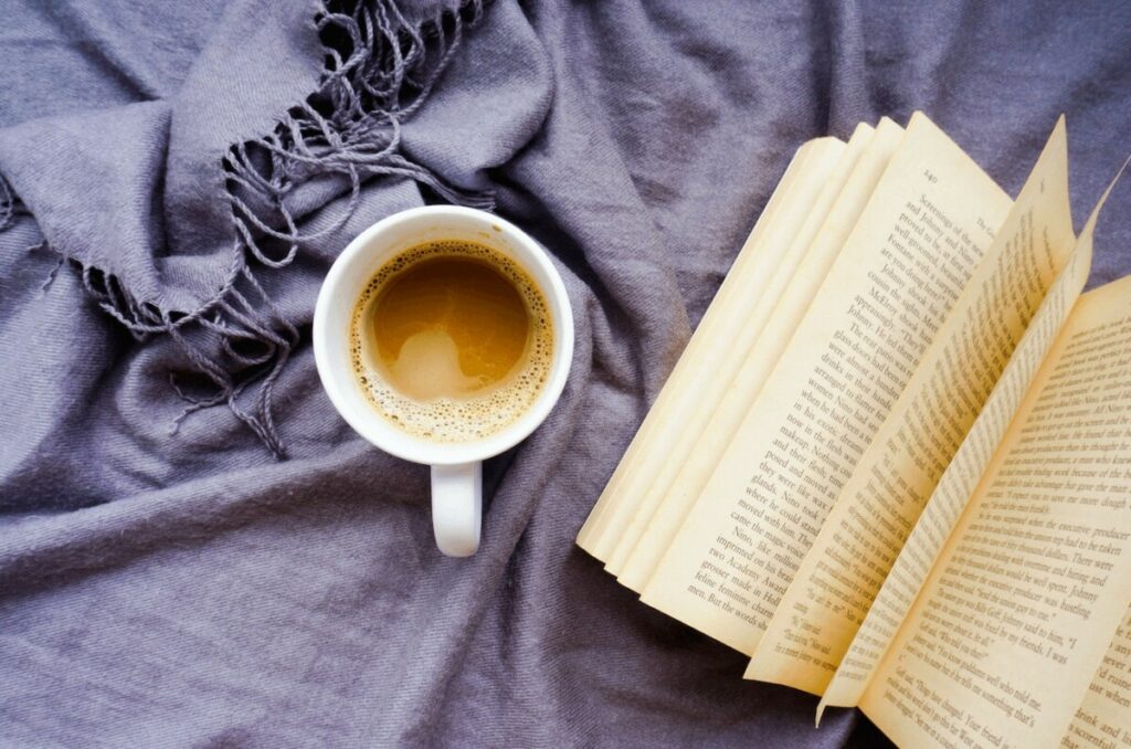 overhead photo of book and coffee