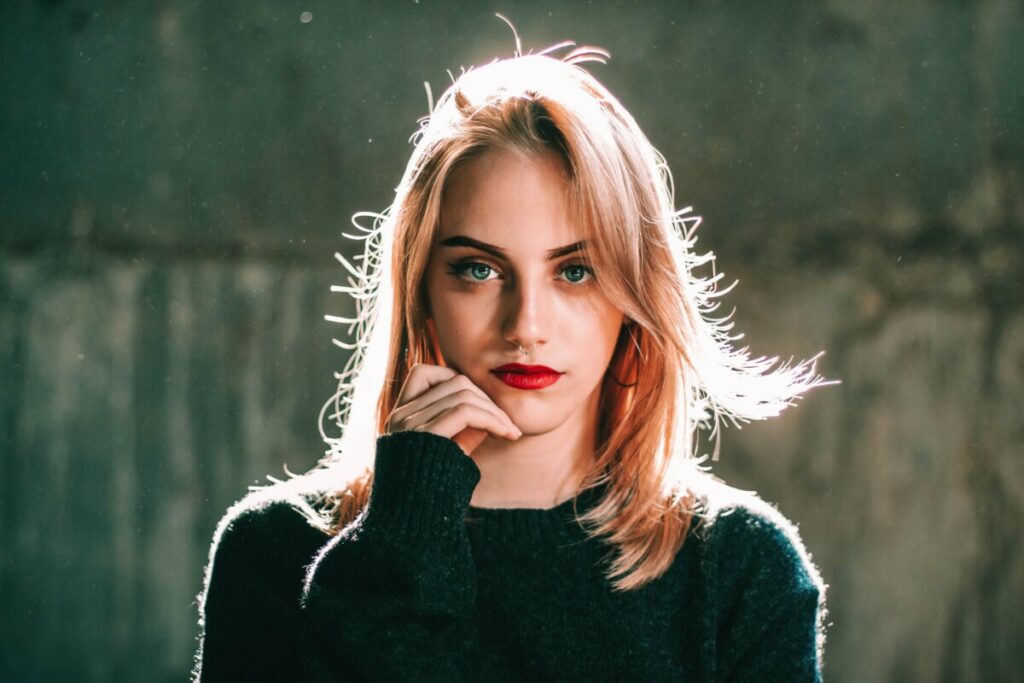 woman with red lips wearing a black sweater